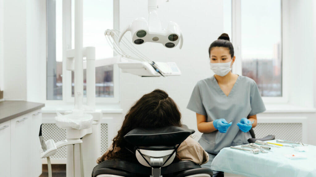 A client and dentist discuss gum health in a dental clinic